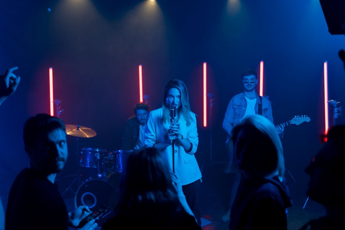 K-pop Group Performing on Stage with Lights