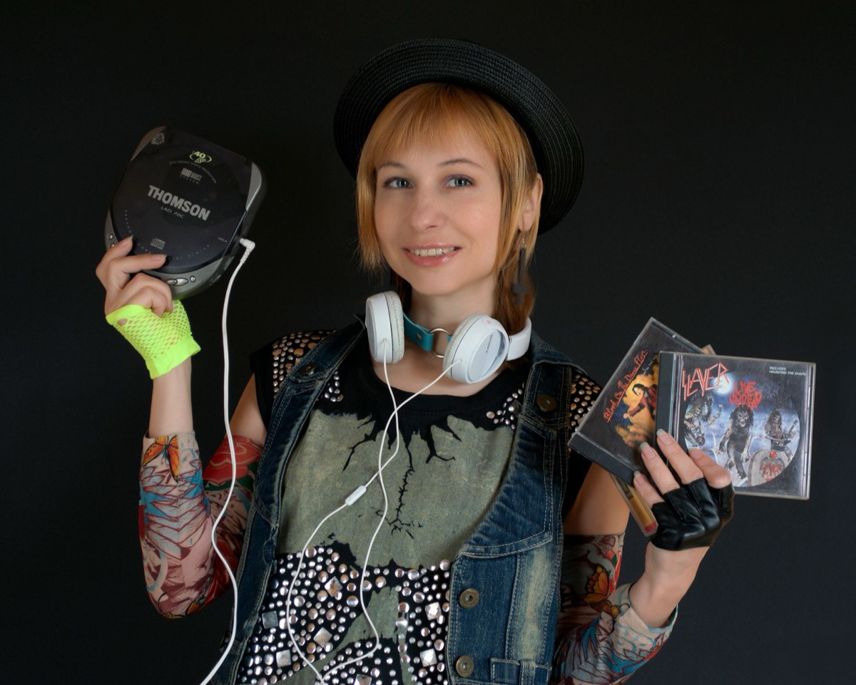 90s K-pop fan holding record with nostalgic expression