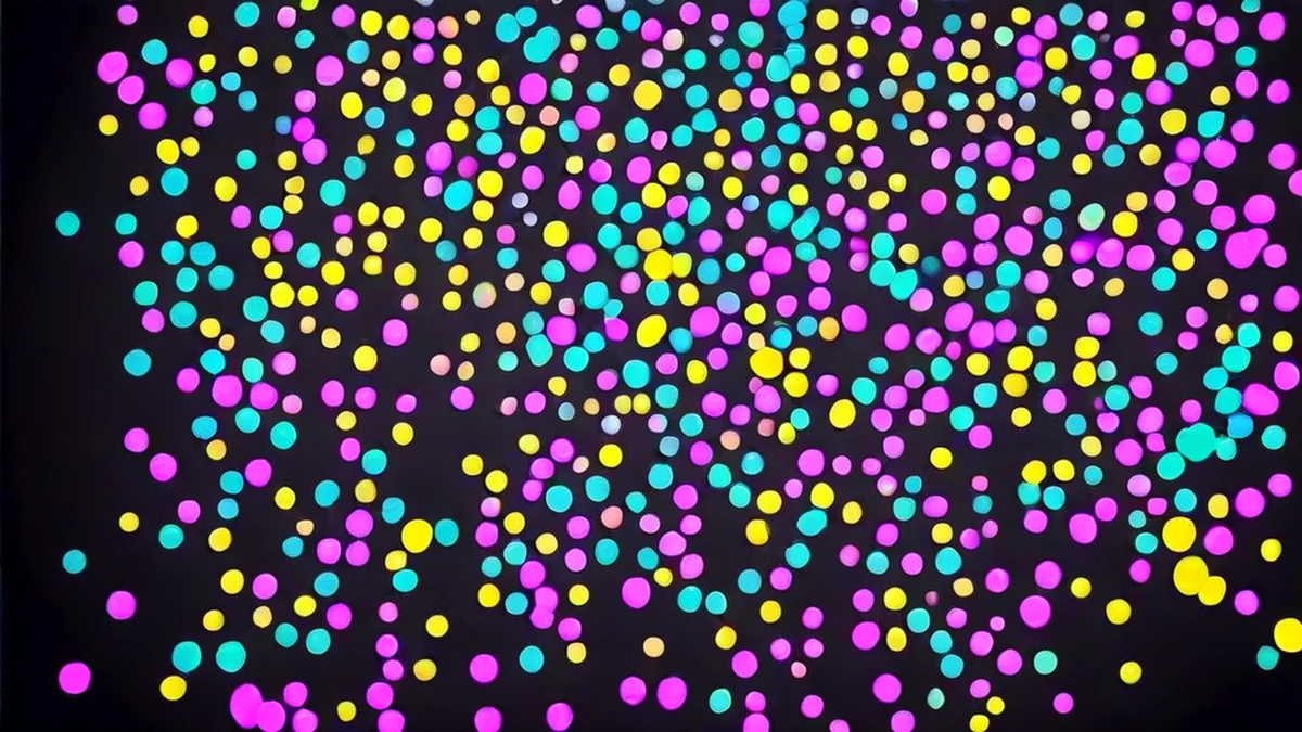 A burst of colorful confetti spreading across a stage.