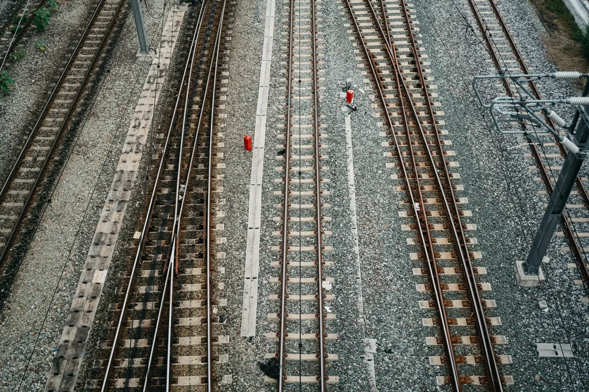Aerial view of multiple railroad tracks in Bangkok, showcasing the urban transportation infrastructure.